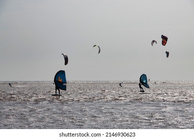 Exmouth, UK - March 22 2022: kite surfers on the beach at Exmouth