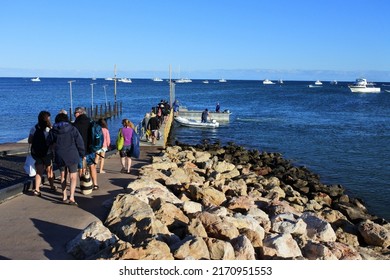 EXMOUTH, WA - MAY 19 2022:line of tourists waiting to board on a whale sharks tour boats.Exmouth is the base to explore the underwater wonders of the Ningaloo Marine Park in Western Australia.