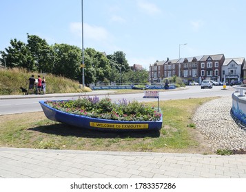 Exmouth/UK-July 2020: A boat decorated with planted flowers servers as a Welcome to Exmouth sign, in Exmouth, England