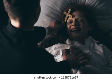 Exorcist Holding Cross Over Laughing Demon In Bed