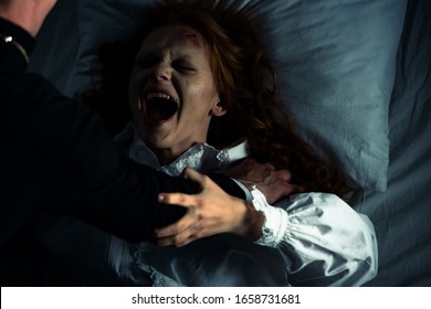 Exorcist Holding Yelling Obsessed Girl In Bed