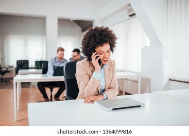 Exotic businesswoman talking on the phone in co working office. - Shutterstock ID 1364099816