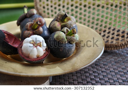 exotic fruit mangosteen on golden plate