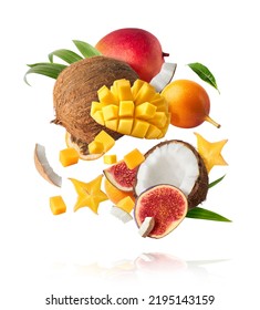 Exotic fruit mix, coconuts, mango, fig, passiflora, carambola falling in te air isolated on white background. Food levitation, zero gravity conception. High resolution image
