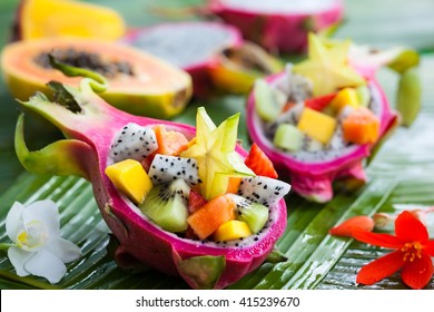 Exotic fruit salad served in half a dragon fruit - Shutterstock ID 415239670
