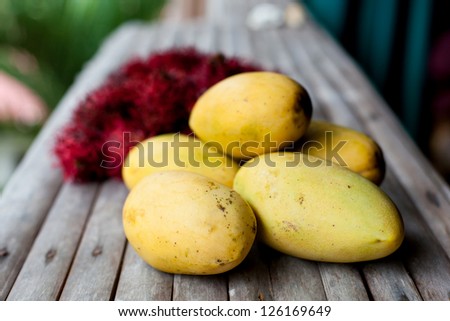 Exotic fruits closeup on wooden table
