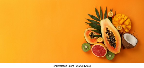 Exotic fruits set on orange background, space for text. - Shutterstock ID 2220847033