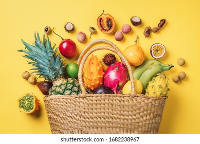 Exotic fruits in straw summer bag. Tropical pineapple, banana, pitahaya, kiwano, african horned melon, tamarillo fruit, granadilla, salak, snake fruit, maracuya, rambutan, lychee, longan, tamarind - Shutterstock ID 1682238967