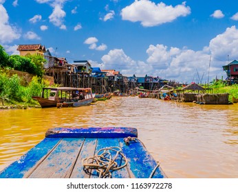Exotic Kampong Phluk floating village with stilt houses and multicolored boats, Tonle Sap lake, Siem Reap Province, Cambodia

