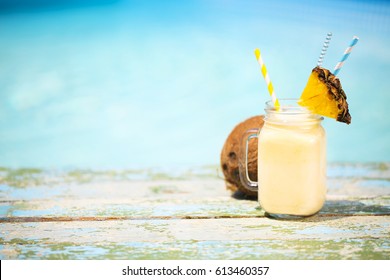 Exotic pineapple cocktail near pool. Pina colada