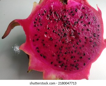 Exotic Pink Dragonfruit Cut Macro Photo On Background. Dragon Fruit Close Up. Pitahaya Texture Photo. Sweet Tropical Fruit, Juicy Pitaya Cut