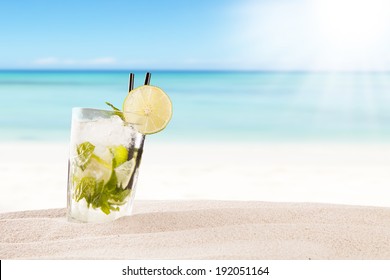 Exotic summer drink in sand, blur beach on background
