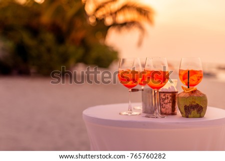 Exotic summer drinks and beach coctails, blur sandy beach and palm trees on background. Copy space for text