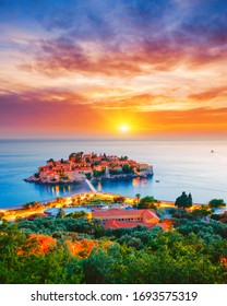 Exotic sundown over the small islet Sveti Stefan. Location place Montenegro, Adriatic sea, Europe. Image of most popular european travel destination. Holiday concept. Discover the beauty of earth.