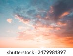 Exotic sunset and soft pink clouds of pastel tones. Scenic image of textured sky. Perfect summertime wallpaper. Bright epic sky. Dramatic evening light and fiery orange sunset. Beauty of earth.