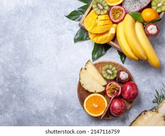 exotic tropical fruits on a gray concrete background. view from above - Shutterstock ID 2147116759