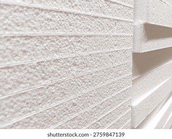 Expanded polystyrene boards in a neat stack — white, lightweight, and uniformly grooved surface