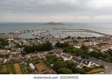 Expansive aerial view of Howth, capturing the entire harbour in full frame with Ireland’s Eye Island in the background