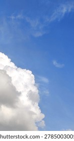Expansive blue sky frames fluffy white cumulus clouds, hinting at serene weather and boundless potential. with intricate details.