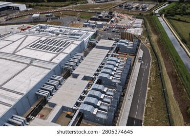 An expansive data center campus is visible from an aerial perspective during the day.