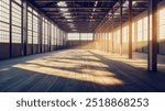 An expansive industrial warehouse with metal beams and large windows, casting light patterns on the wooden floor