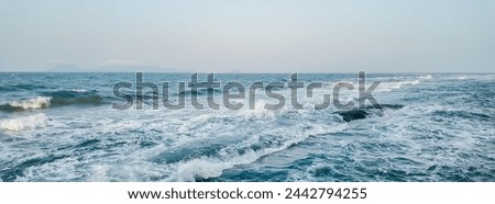 Expansive ocean view with choppy waves and tranquil horizon, ideal for backgrounds and textual overlays, conveys a sense of marine adventure or peaceful getaway concepts