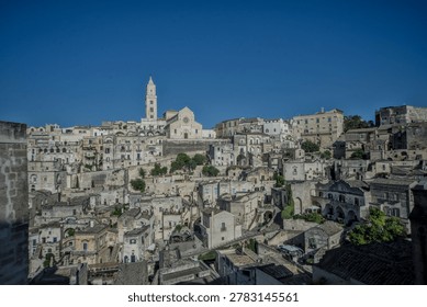 Expansive panoramic view of the densely packed ancient stone sassi district of Matera, Basilicata, Italy, stretching across the hillside.