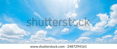 Expansive panoramic view of tranquil blue sky and fluffy white clouds on peaceful day, serene natural atmosphere for calm backgrounds, wide open airy skies landscape in daylight, panorama
