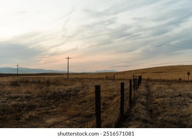 Expansive rural landscape with power lines, open fields, mountain! - Powered by Shutterstock