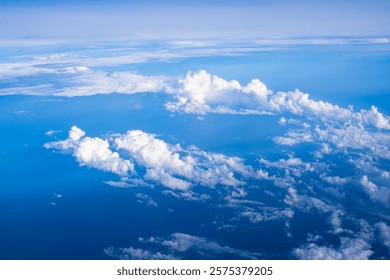 Expansive view of clouds over the ocean captured from an airplane at cruising altitude during a clear day