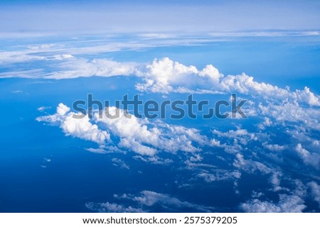 Expansive view of clouds over the ocean captured from an airplane at cruising altitude during a clear day