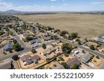 Expansive view of a suburban neighborhood under a clear blue sky