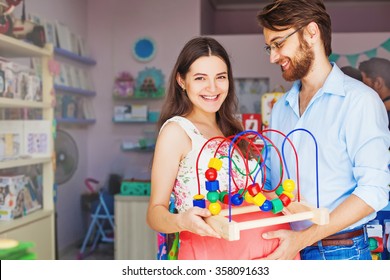 Expectant Parents Buying Baby Toy