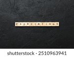 expectation word written on wood block. expectation text on table, concept.