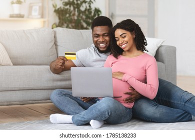 Expecting African American Parents Buying Baby Stuff Online From Home, Using Laptop And Credit Card, Free Space