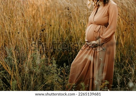 Expecting mom during her maternity photoshoot for third child.