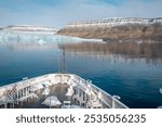 Expedition cruise ship near glacier at Crocker Bay on Devon Island, reflection  in calm water, Canadian Arctic, Nunavut