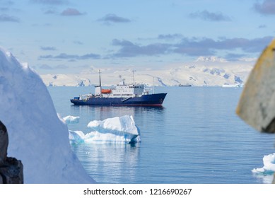 Expedition Ship With Iceberg In Antarctic Sea