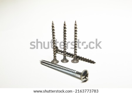 expendable materials. Self-tapping screws and screws on a white background