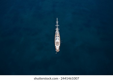 Expensive classic wooden sailing yacht on blue water top view. Large sailing yacht, top view. Anchorage sailing yacht on dark water top view. - Powered by Shutterstock