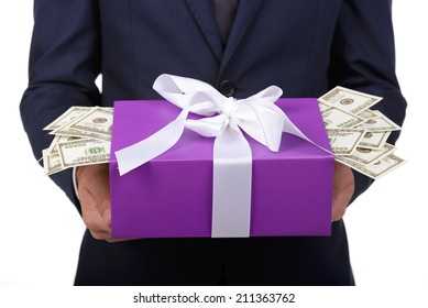 Expensive Gift. Happy Young Man In Formalwear Holding A Gift Box Full Of Money While Standing Isolated On White