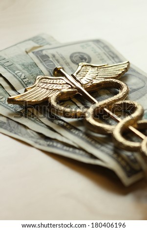 Expensive healthcare concept, caduceus on US money