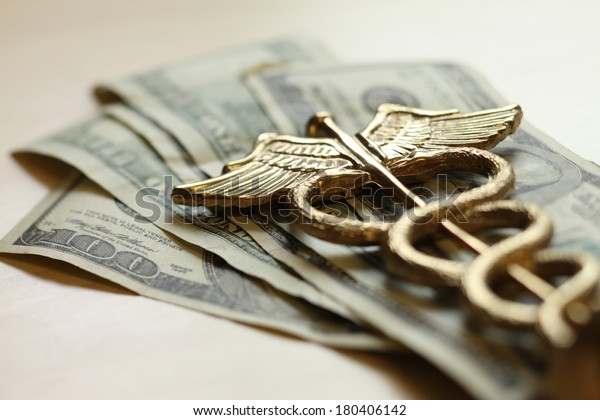 Expensive healthcare concept, caduceus on US money