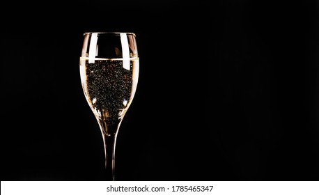 Expensive And Luxurious Vintage Champagne With Delicate Bubbles In A Wine Glass On A Black Background, Exclusive Drink