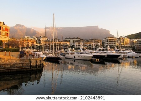 Expensive luxury boats in the marina at the VA Waterfront, with Table Mountain in the Background, in the late afternoon, Cape Town South Africa