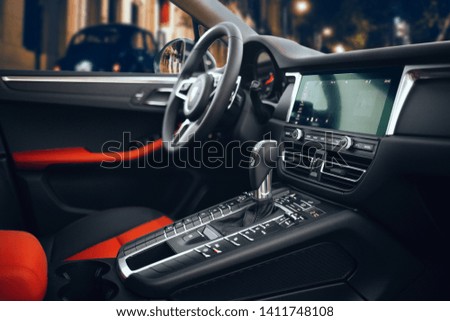 Expensive and luxury car interior with steering wheel, multimedia, control panel and gearbox