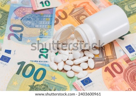 Expensive Medicine and Inflation Concept: Pills and Capsules on the Euro Banknotes. Global Pharmaceutical Industry and Big Pharma. Euro Money Bills