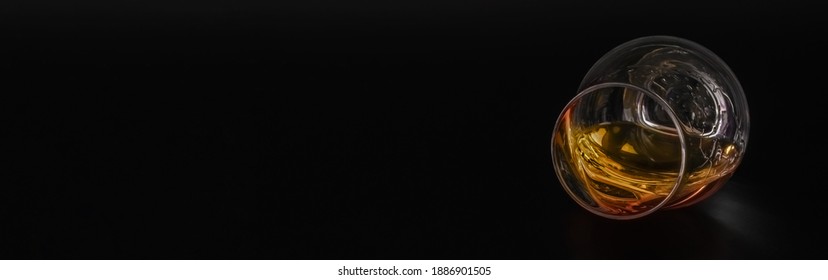 Expensive Single Malt Whisky In A Tasting Glass On The Black Background