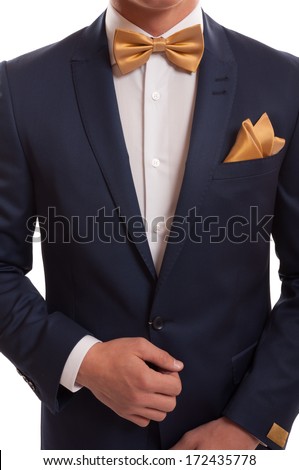 Expensive suit, golden bow tie and elegant handkerchief.