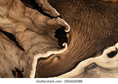 Expensive Vintage Furniture. The Table Is Covered With Epoxy Resin And Varnished. Luxury Quality Wood Processing. Wooden Table On A Dark Background. A Gold Epoxy River In A Rectangular Tree Slab.